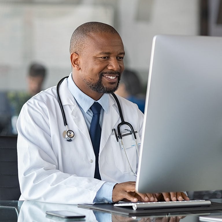 Male doctor working on computer