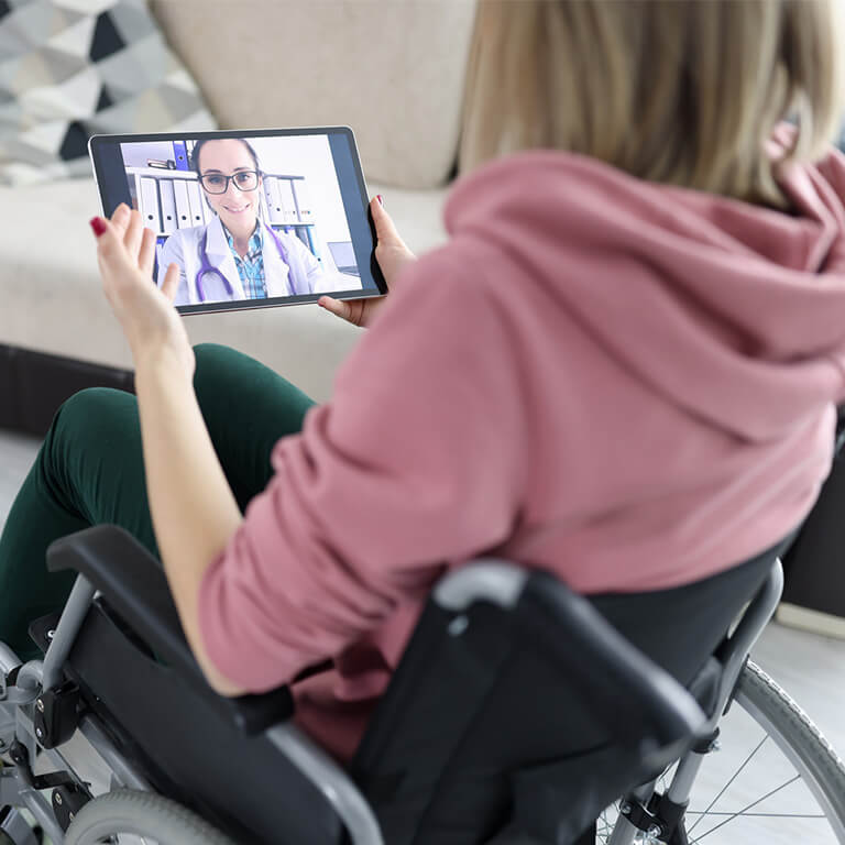 A woman in a wheelchair attends a virtual doctor's visit